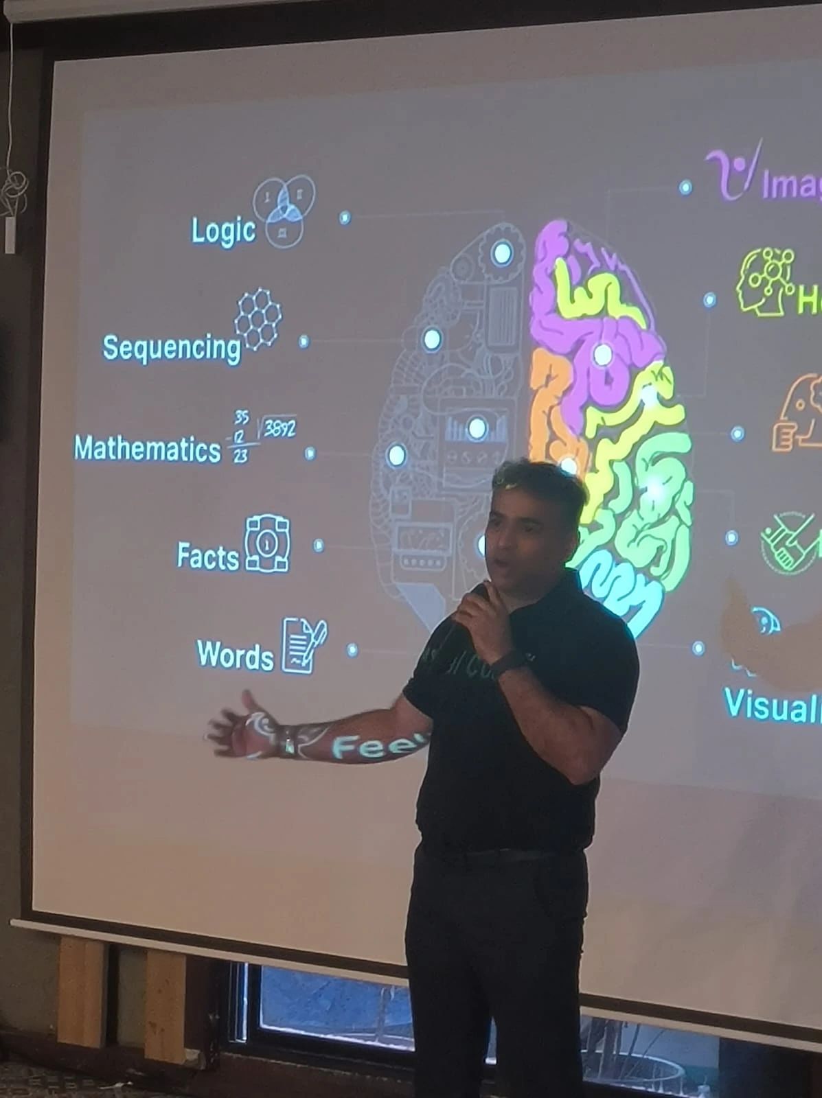 Aleem Merchant speaking at a corporate event